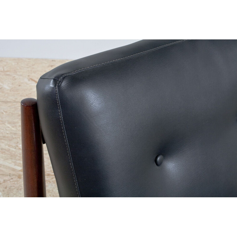 Pair of rosewood and black leatherette armchairs by Grete Jalk