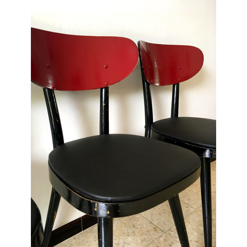 Suite de 4 chaises vintage Baumann en skaï noir et bois 1950