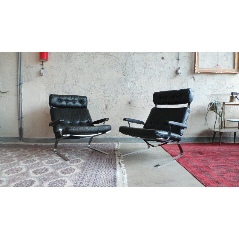 Pair of black leather and steel lounge chairs