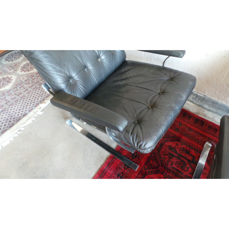 Pair of black leather and steel lounge chairs