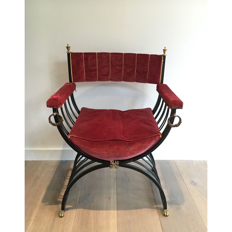 Vintage curule chair in blackened iron and brass and with claw foot decorations