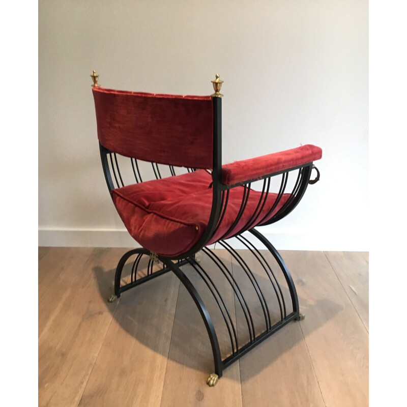 Vintage curule chair in blackened iron and brass and with claw foot decorations