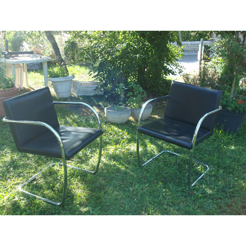 Set of 8 vintage armchairs in black leather and chrome 1970