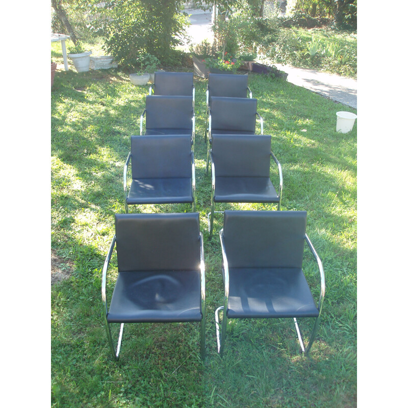 Set of 8 vintage armchairs in black leather and chrome 1970