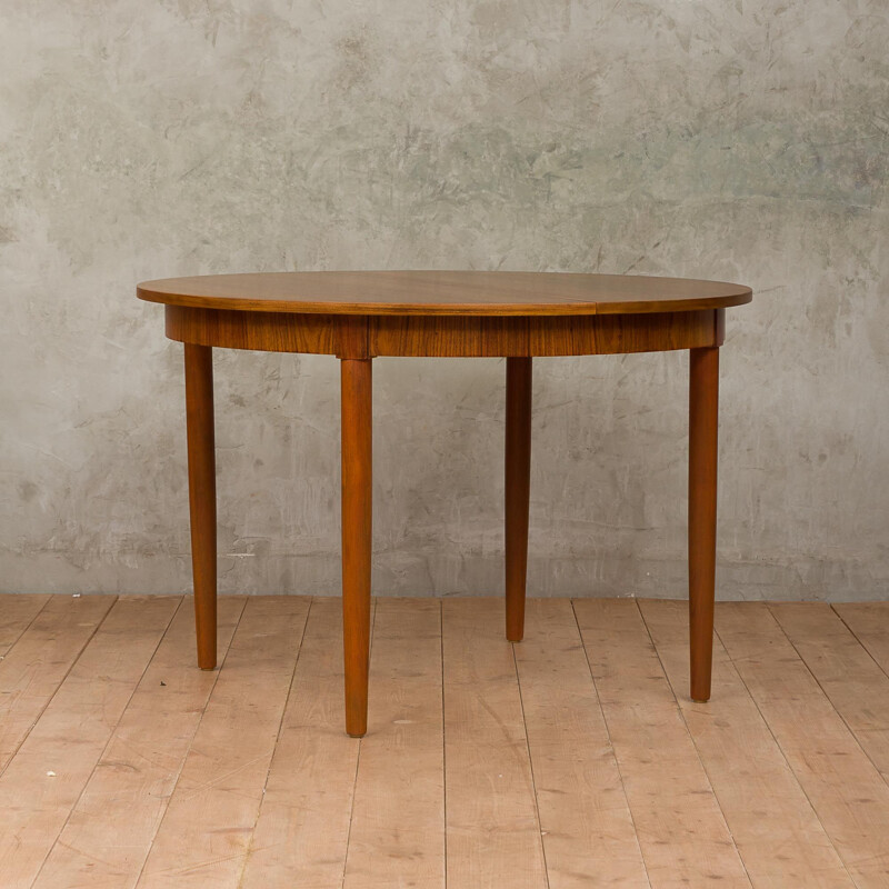 Round extendable dining table by Kai Kristiansen