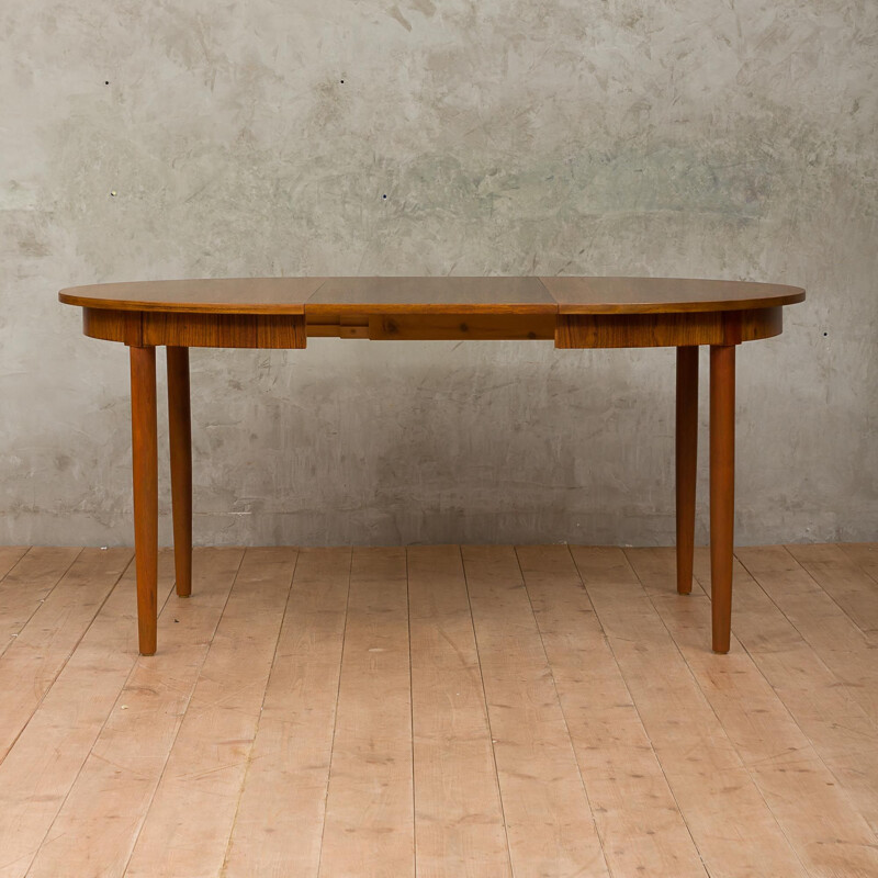 Round extendable dining table by Kai Kristiansen