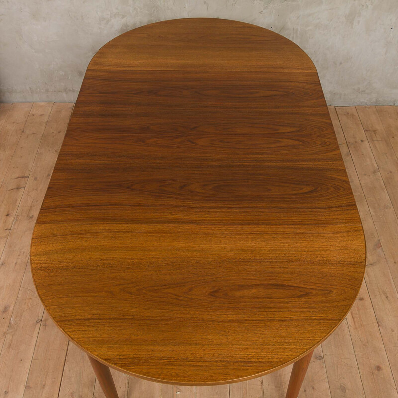 Round extendable dining table by Kai Kristiansen