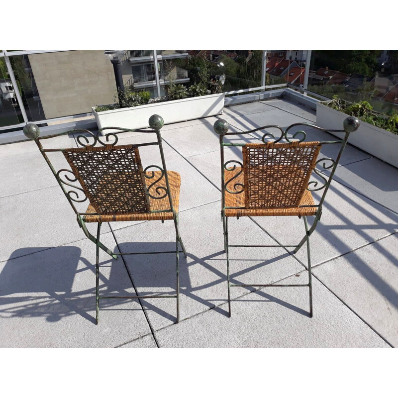 Pair of vintage wrought iron and rattan folding chairs