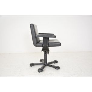 Vintage deskchair swivelling on wheels, in black leather