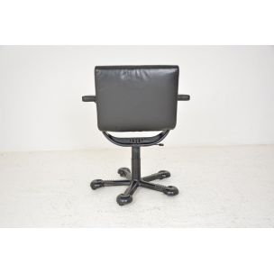 Vintage deskchair swivelling on wheels, in black leather