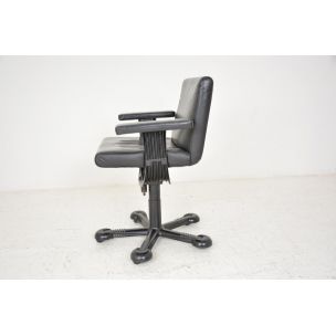 Vintage deskchair swivelling on wheels, in black leather