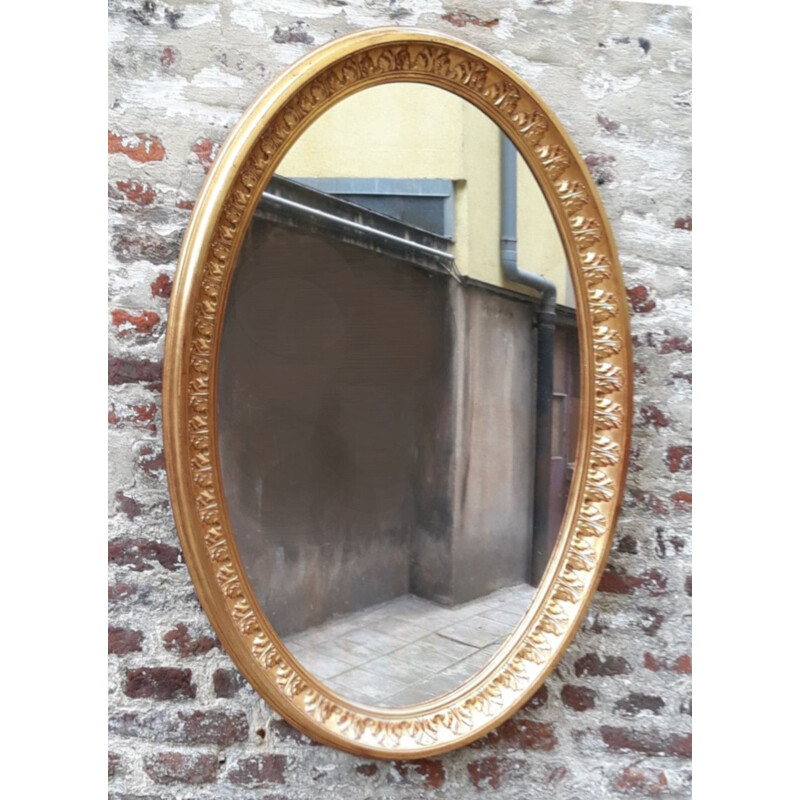 Vintage oval mirror in gilded wood