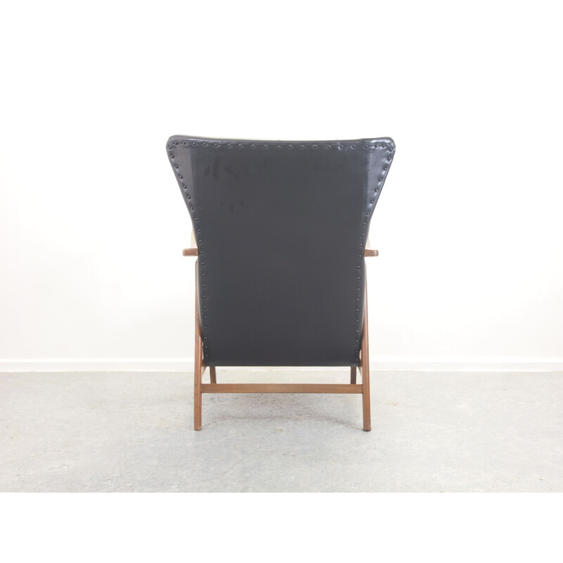 Vintage teak and black padded lounge chair 1950