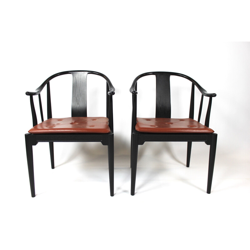 A pair of China chairs of black colored ash by Hans J. Wegner and Fritz Hansen in 2013.