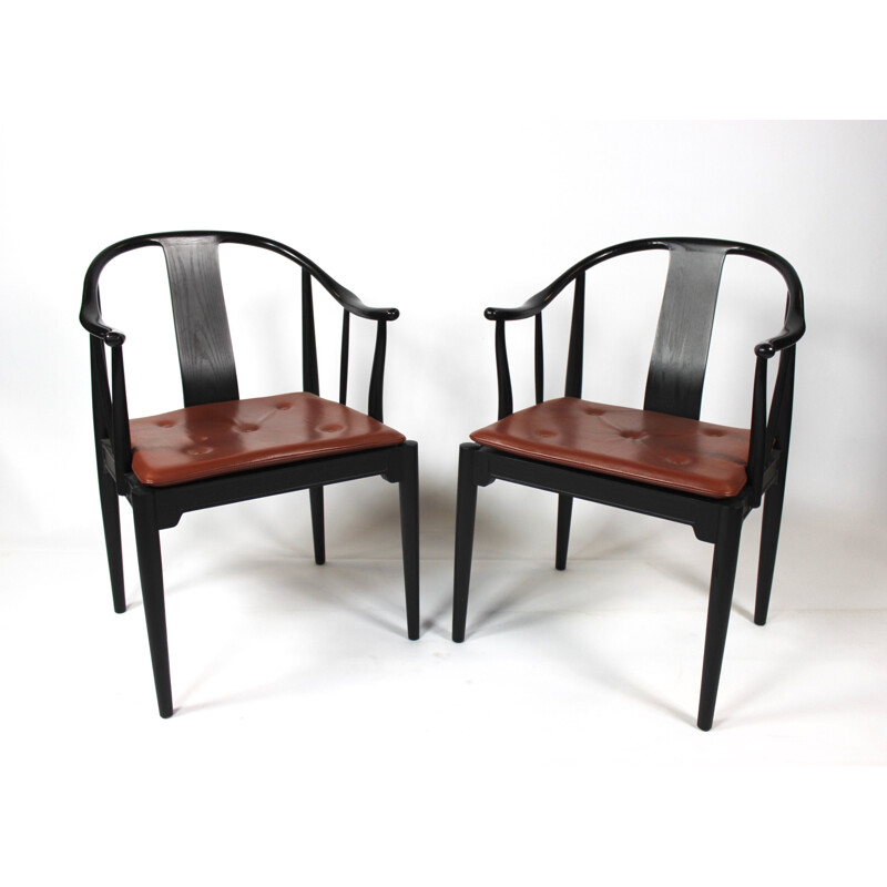 A pair of China chairs of black colored ash by Hans J. Wegner and Fritz Hansen in 2013.